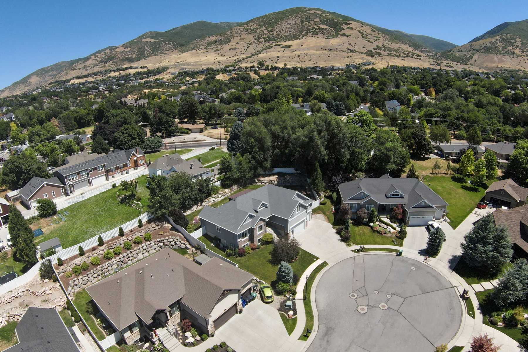 Aerial perspective showcasing residential properties and mountainous terrain