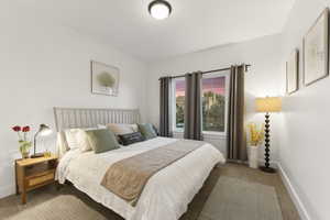 Bedroom featuring carpet floors and baseboards