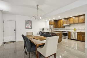 Dining space featuring hanging lights and baseboards