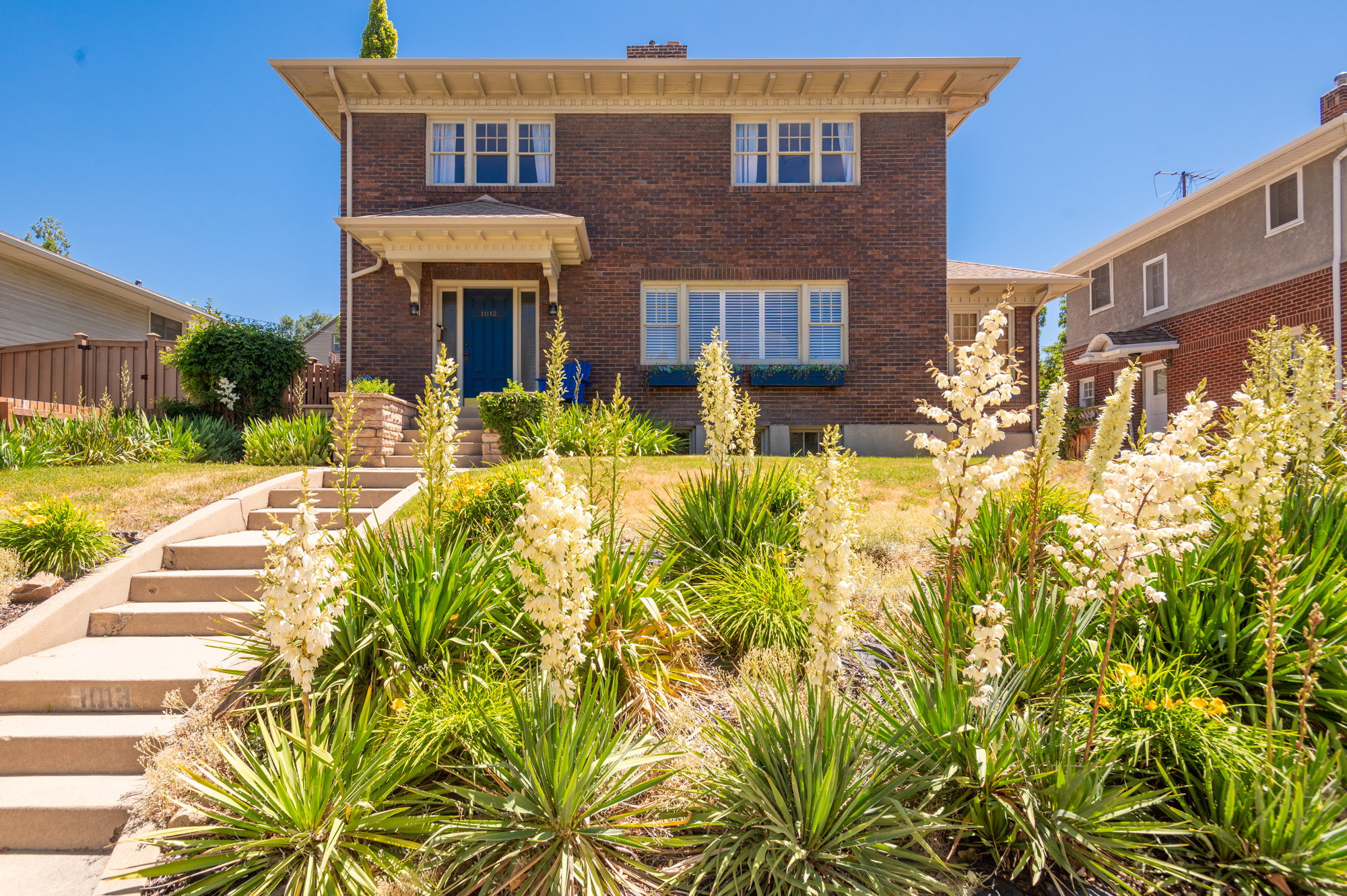 Brick exterior residence featuring a covered front entry with white decorative corbels