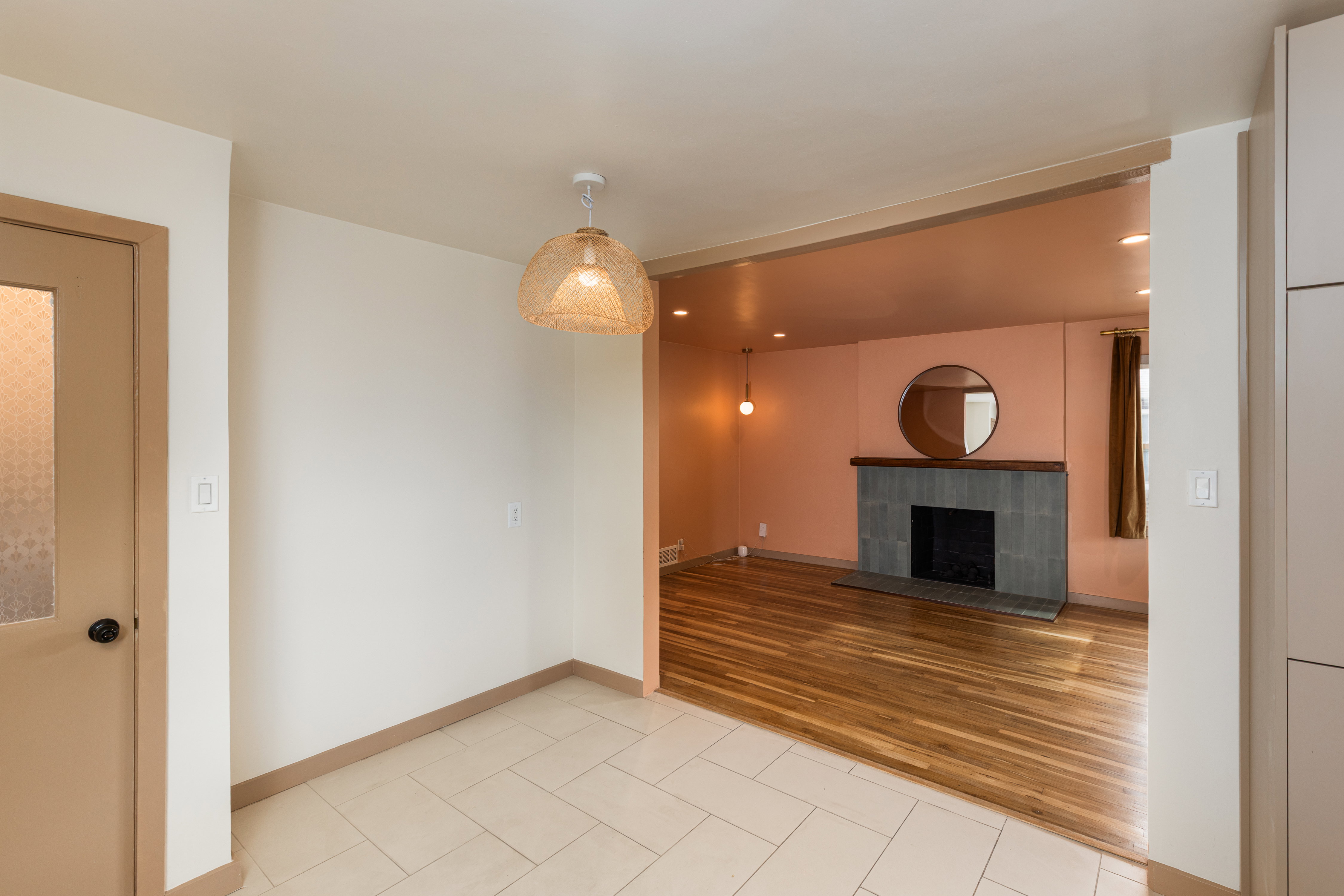Entryway featuring light-toned square floor tiles and a woven pendant light fixture