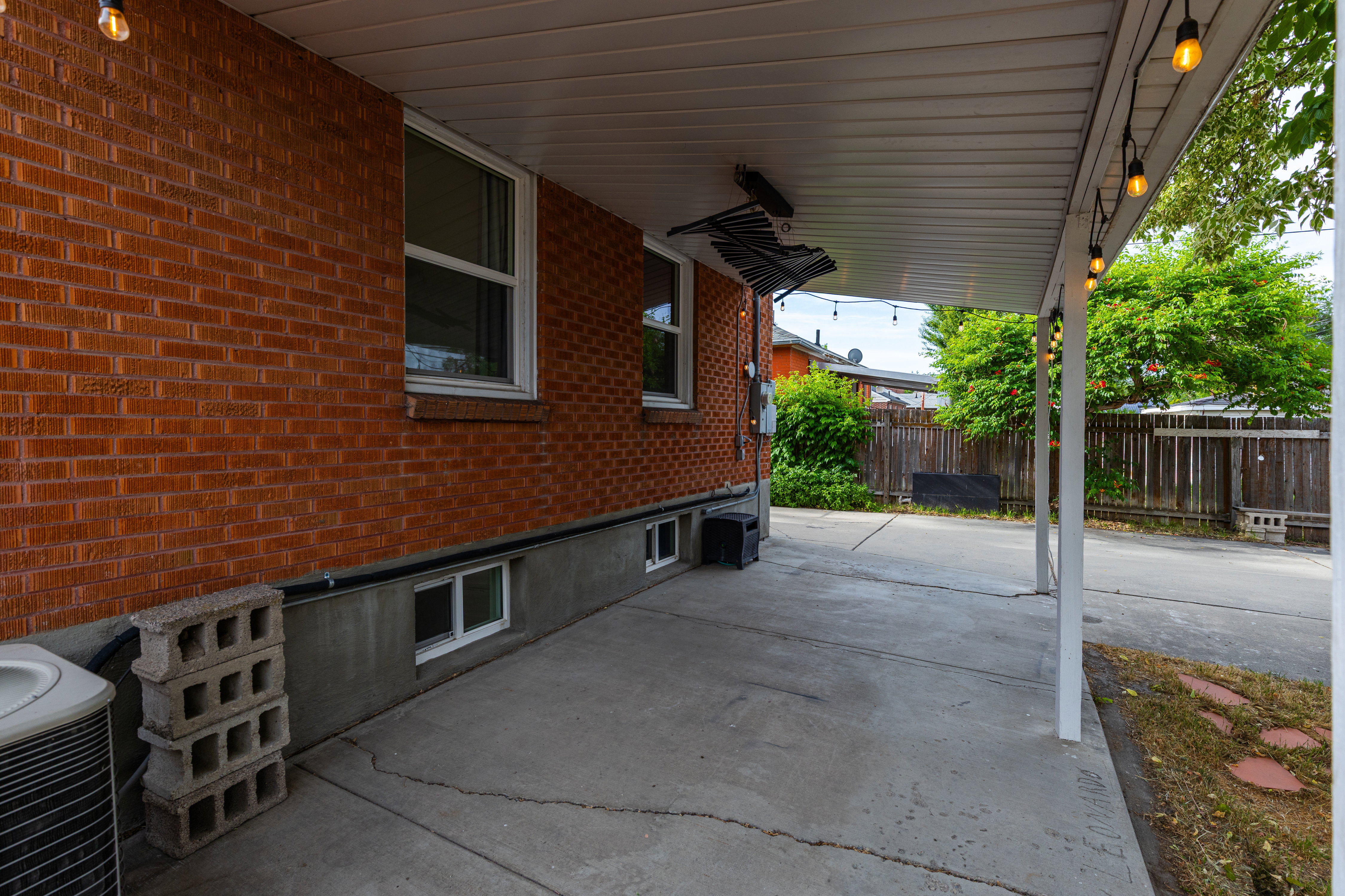 Covered concrete patio with white support columns