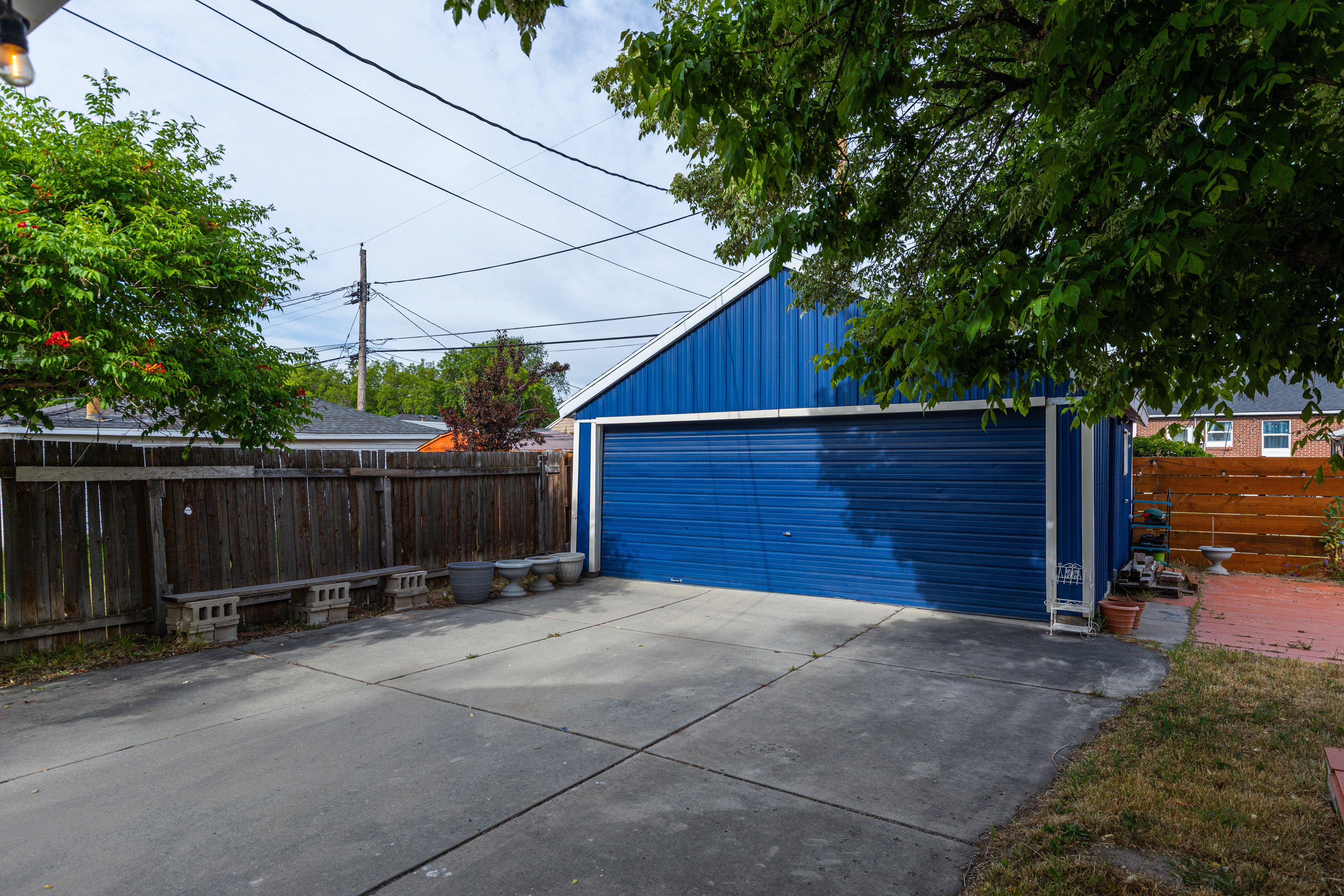 Detached two-car garage with a blue exterior and sloped roof