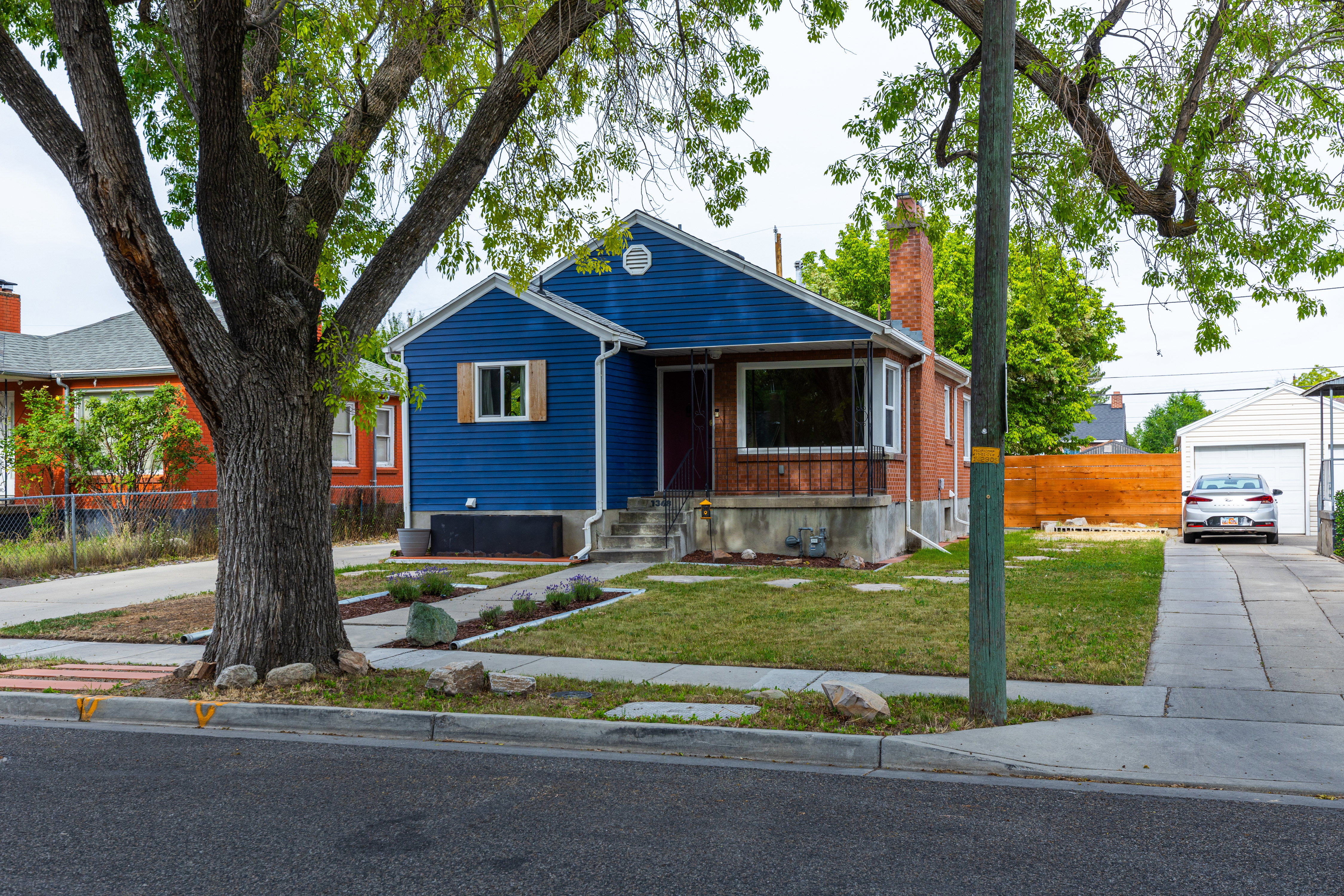 Charming single-family residence featuring blue siding and brick accents