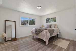Light wood-finish flooring complements white walls with vertical paneling