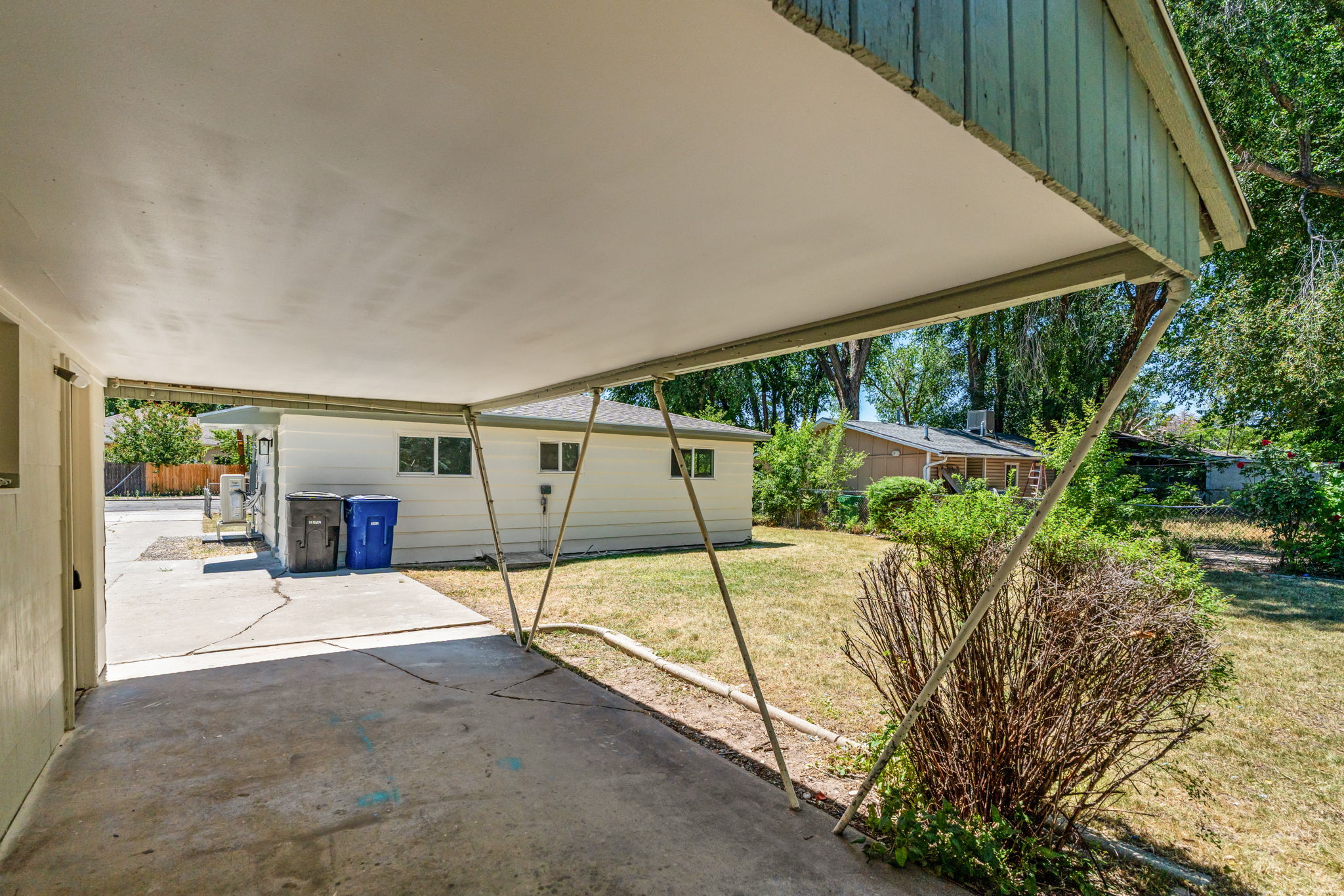 Covered carport with concrete paving