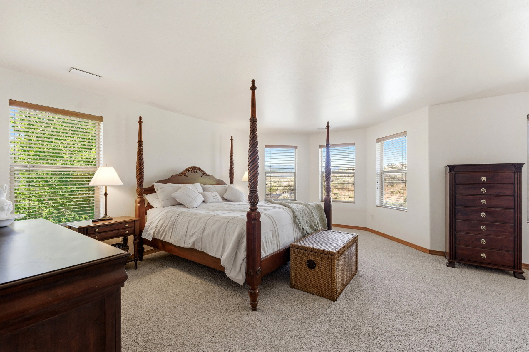 Carpeted room with multiple windows providing natural illumination
