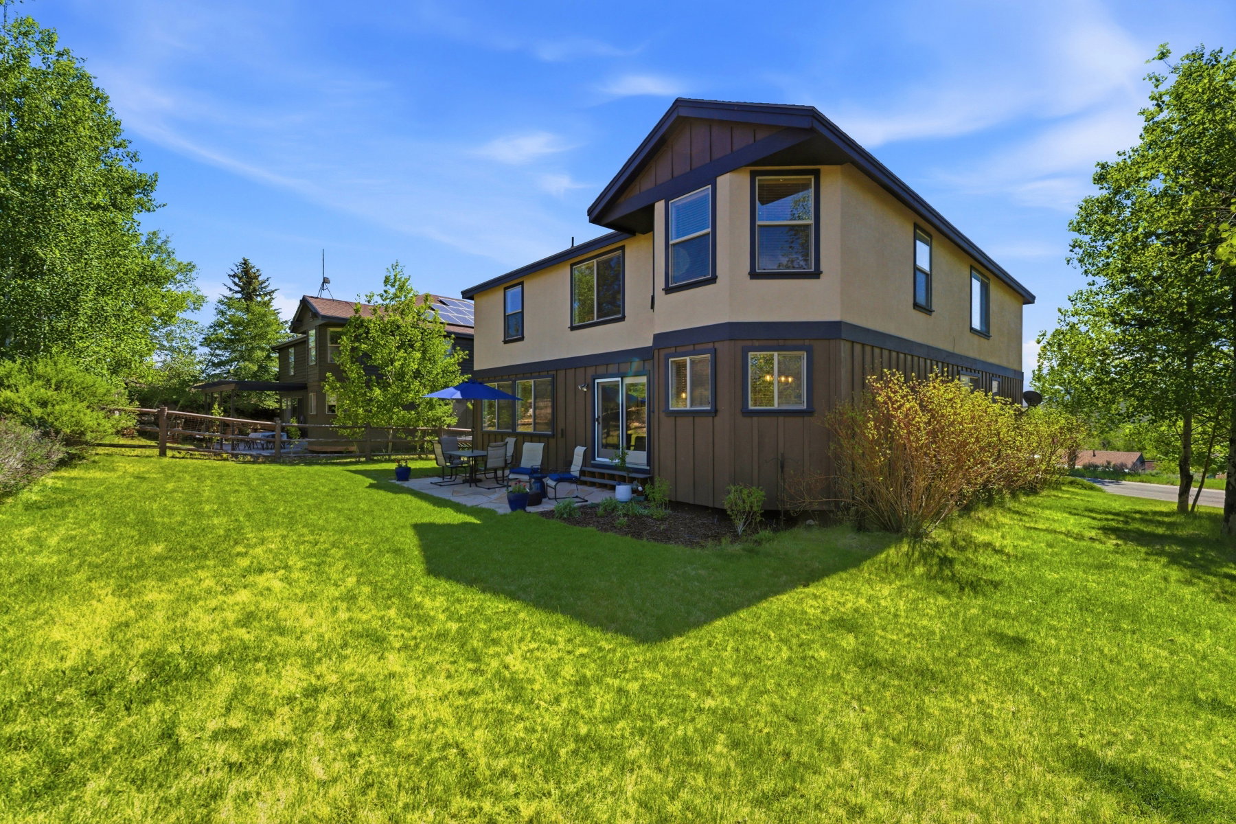 Two-story property featuring a stucco and board-and-batten exterior
