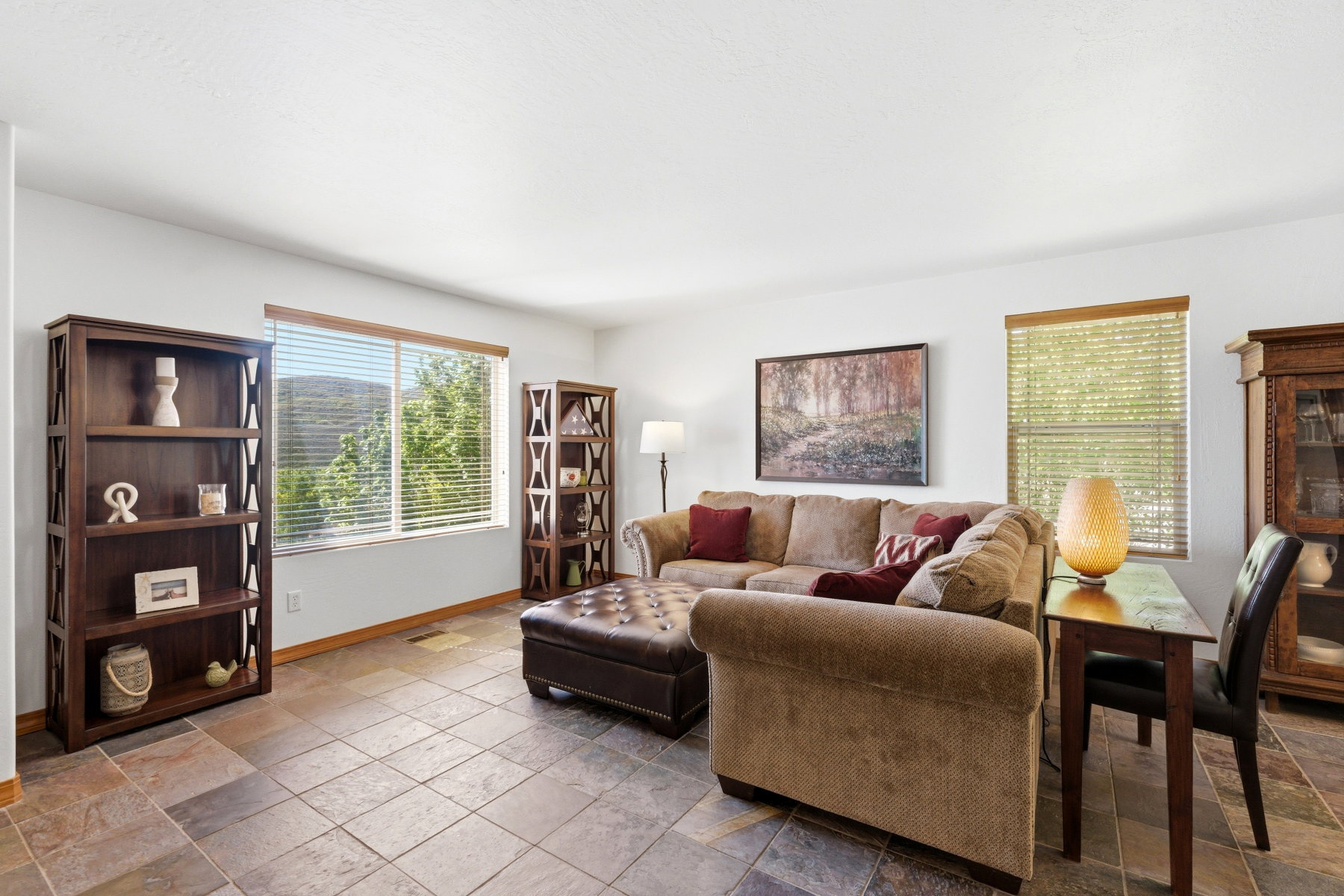 Spacious room featuring large format tile flooring and white walls