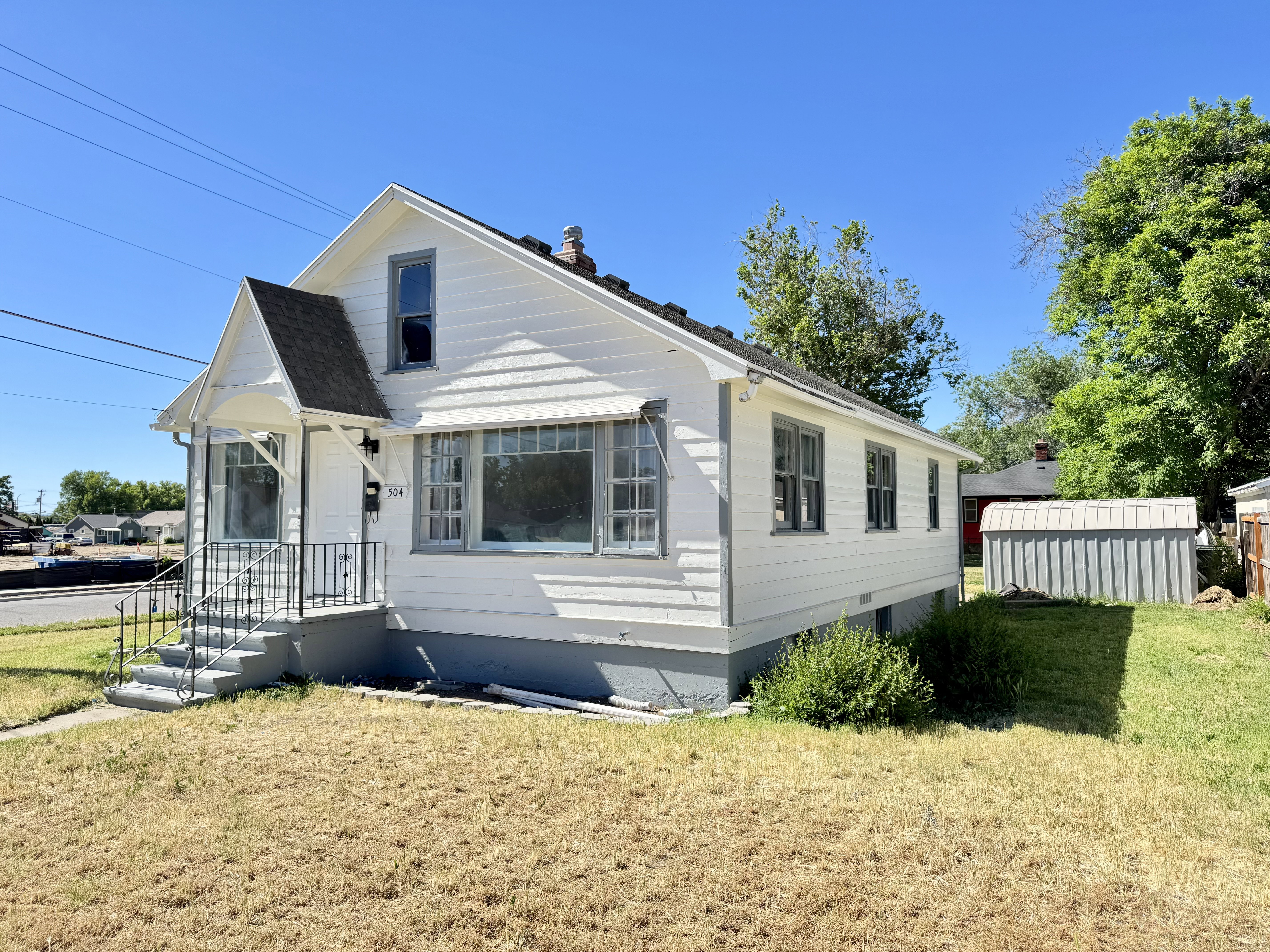 Classic white siding exterior with contrasting gray trim