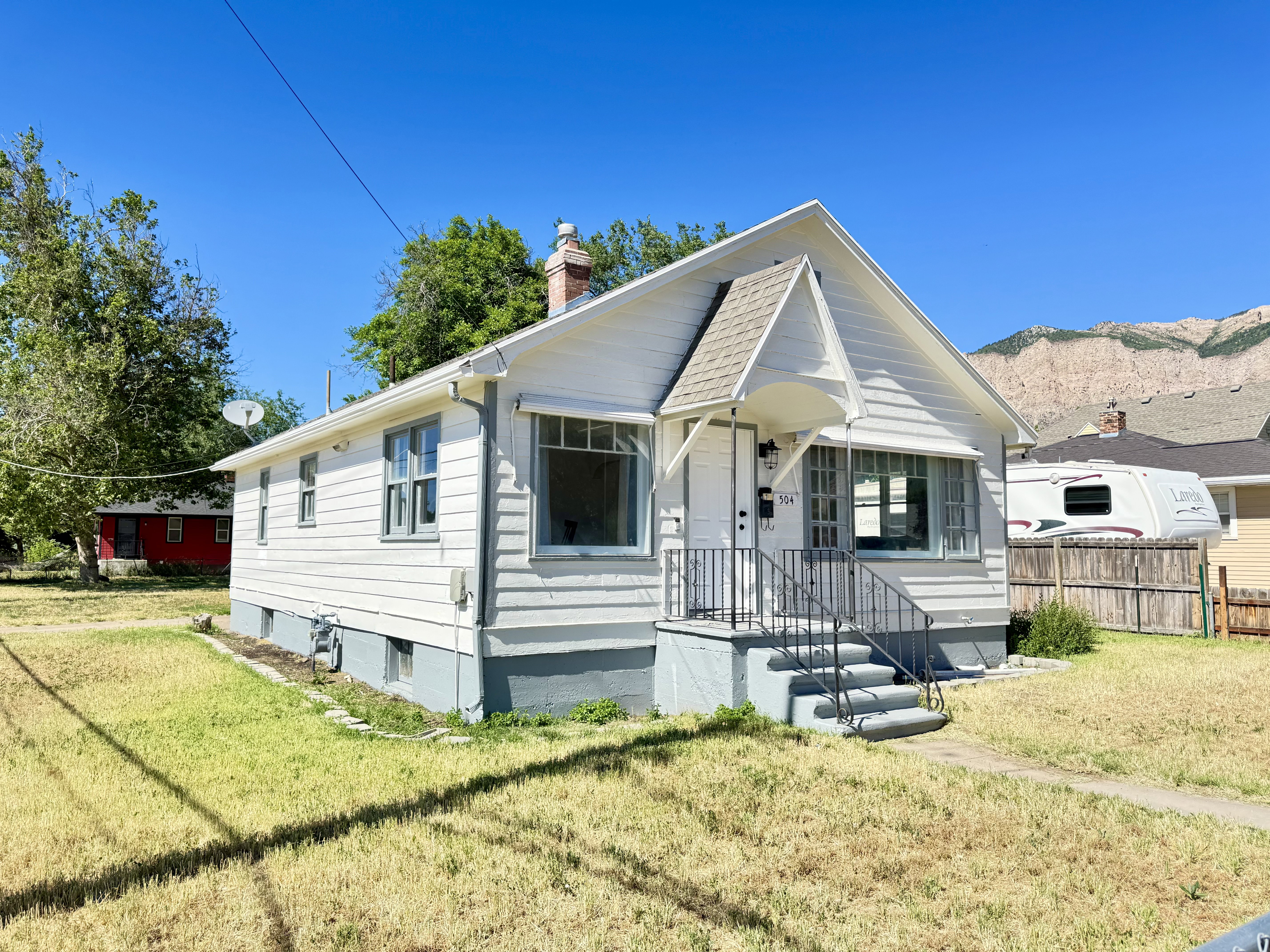 White siding exterior with grey trim accents