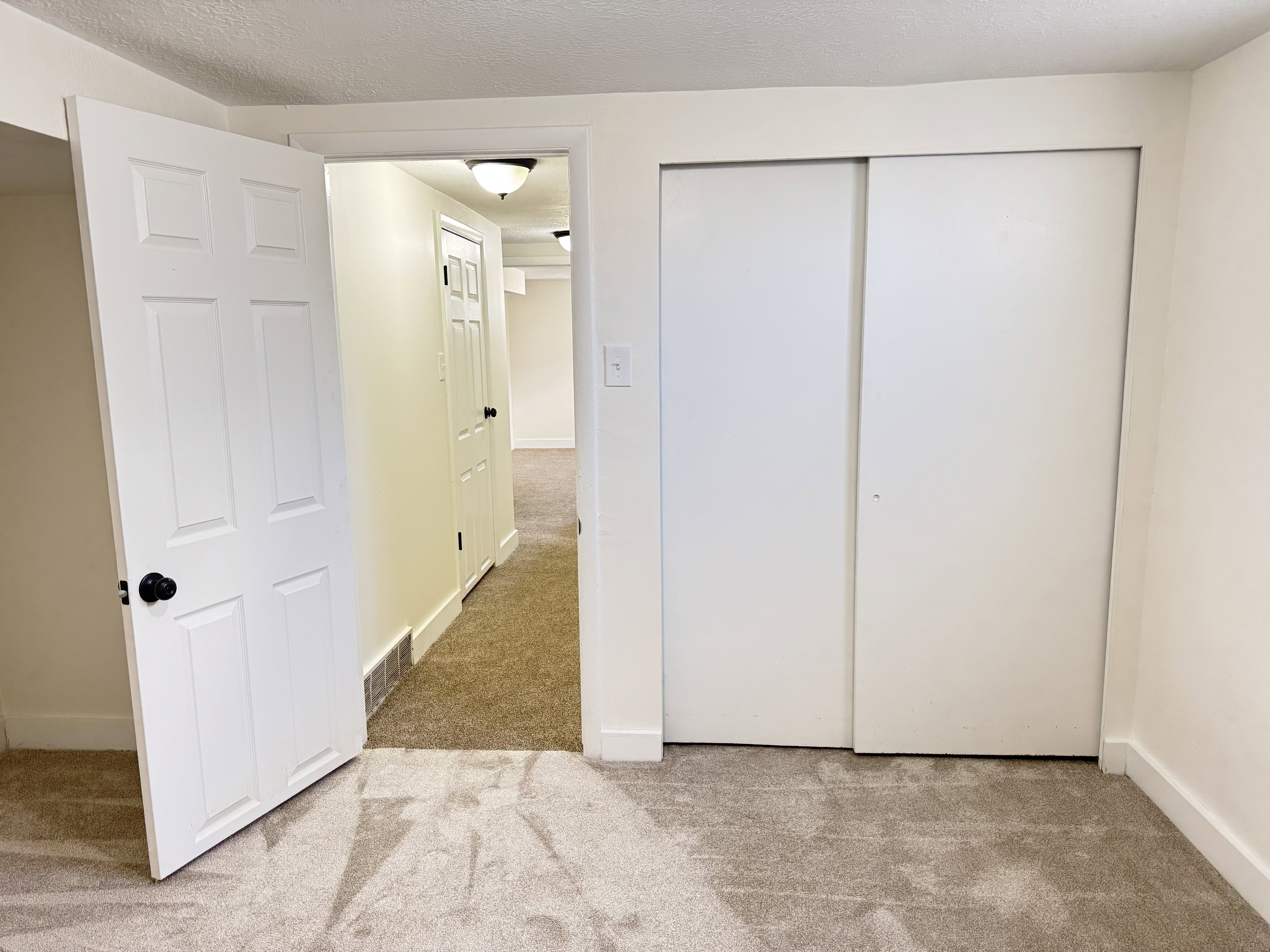 Room featuring neutral tone carpeting and white walls