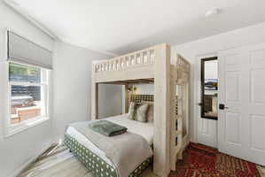 Bedroom featuring light wood-finish bunk beds and light wood-finish flooring