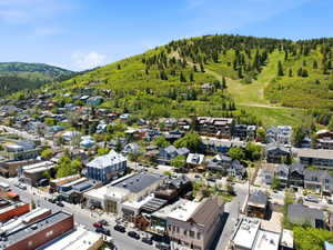 Hillside community featuring varied architectural styles, mature trees, and a mountain backdrop