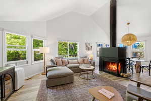 Vaulted ceilings complement wood-finish flooring in this living space