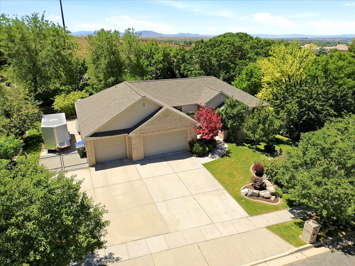 Ranch-style residence featuring a prominent two-car garage, concrete driveway, and a gated side yard