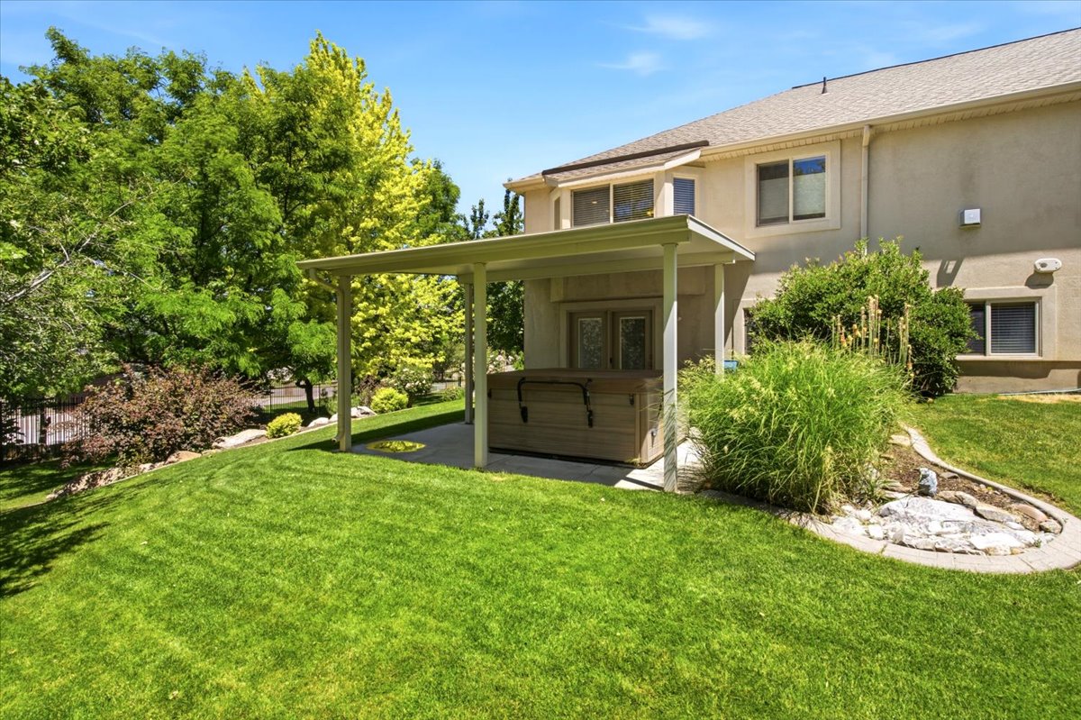 Expansive green lawn with mature trees and established landscaping