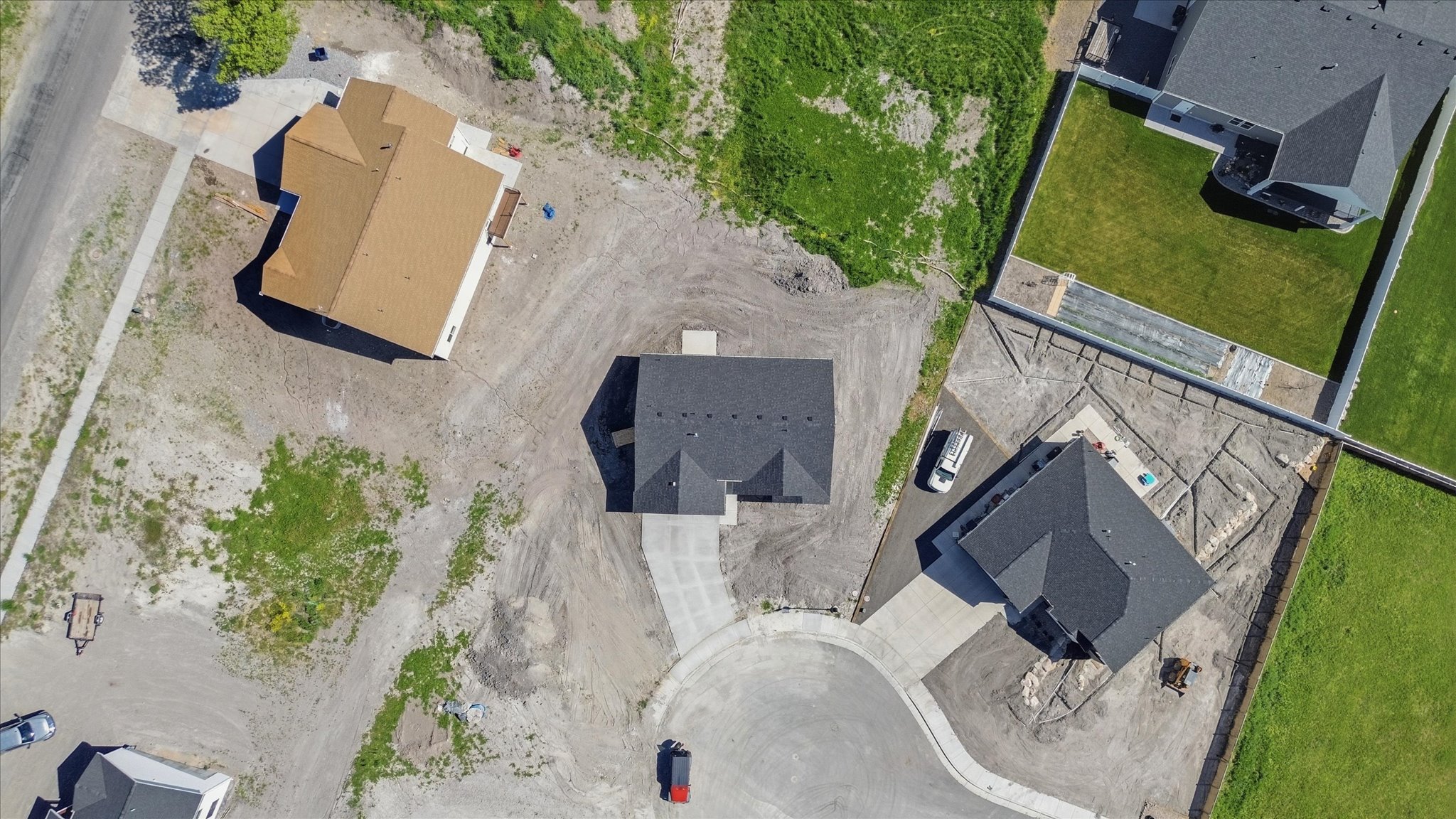 New construction residence featuring a dark shingle roof, a concrete driveway, and an attached two-car garage