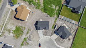 New construction residence featuring a dark shingle roof, a concrete driveway, and an attached two-car garage