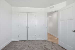 Neutral interior space with light gray carpet and white walls