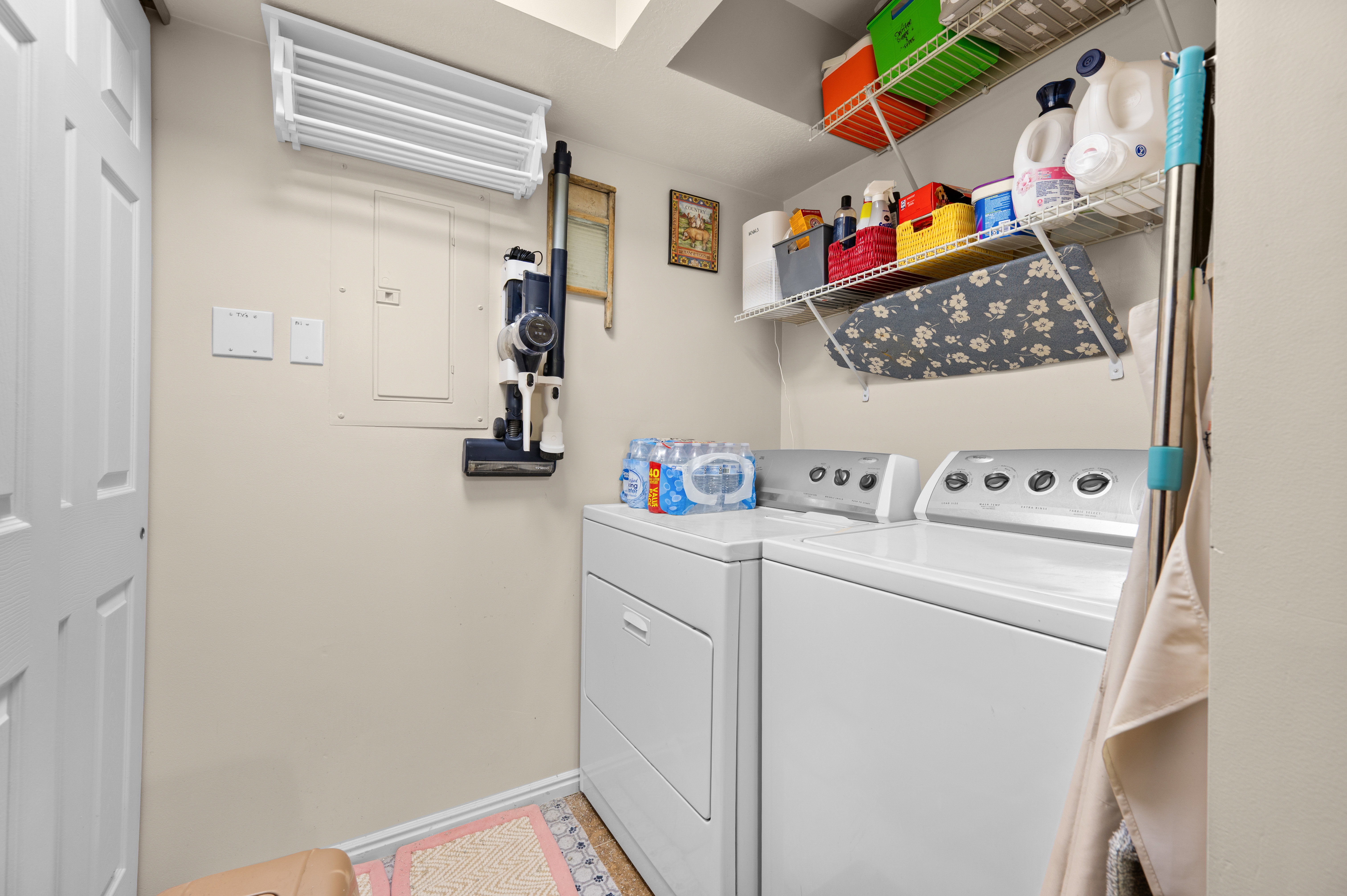 Dedicated laundry area featuring a white top-load washer and front-load dryer