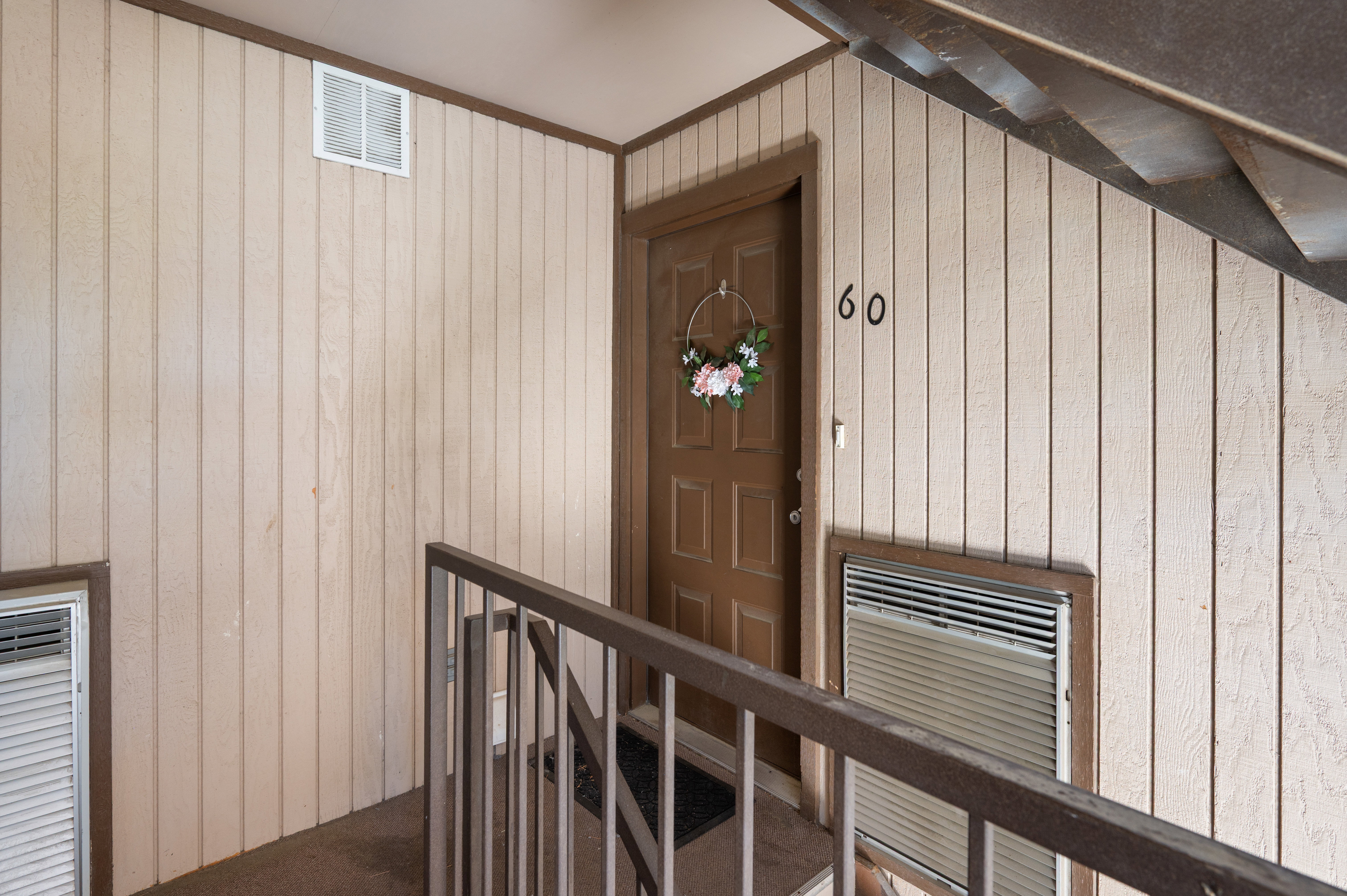 Entryway featuring a paneled door with visible unit numbering and a built-in wall unit