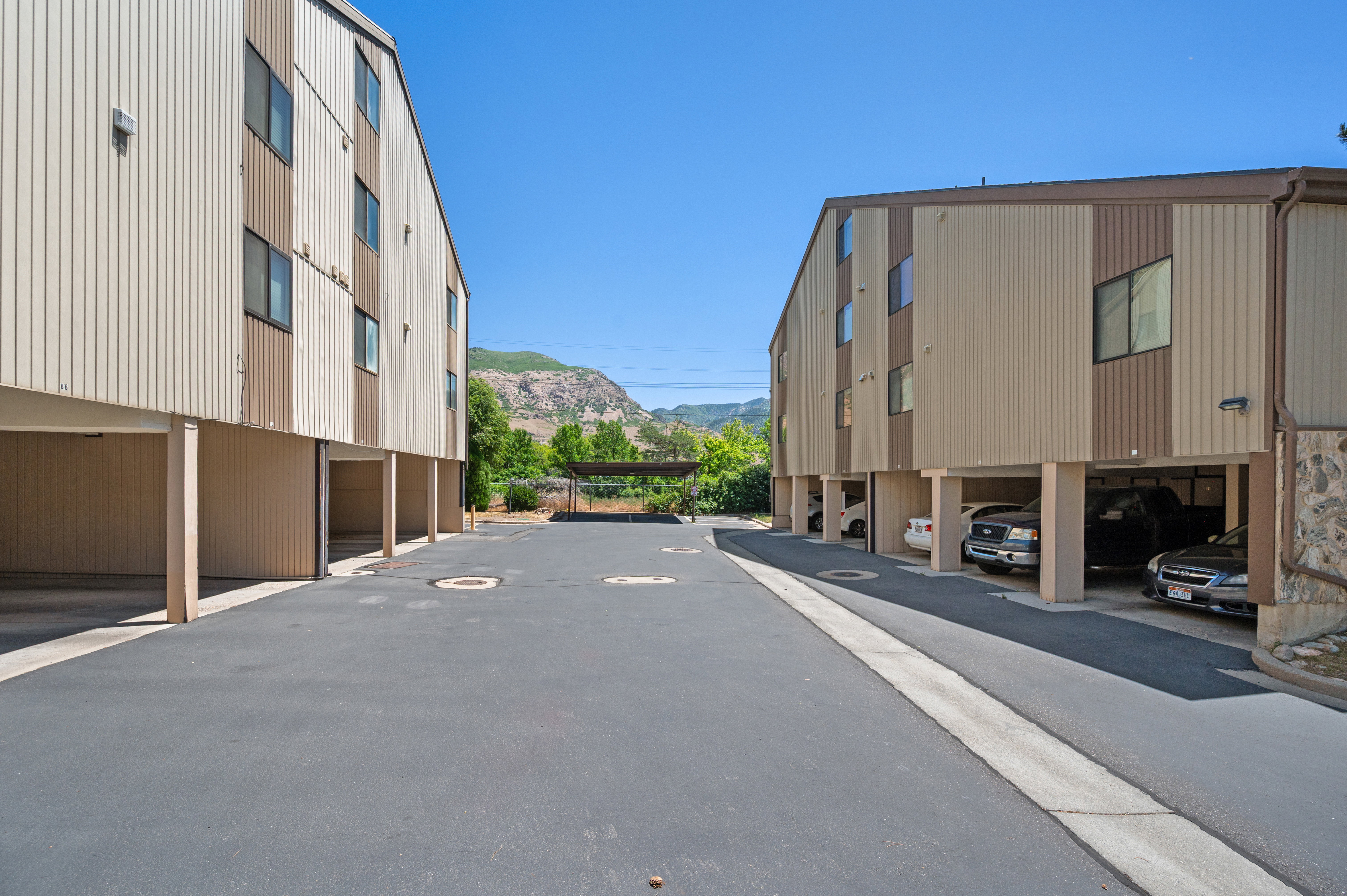 Multi-story building featuring tan and brown vertical siding