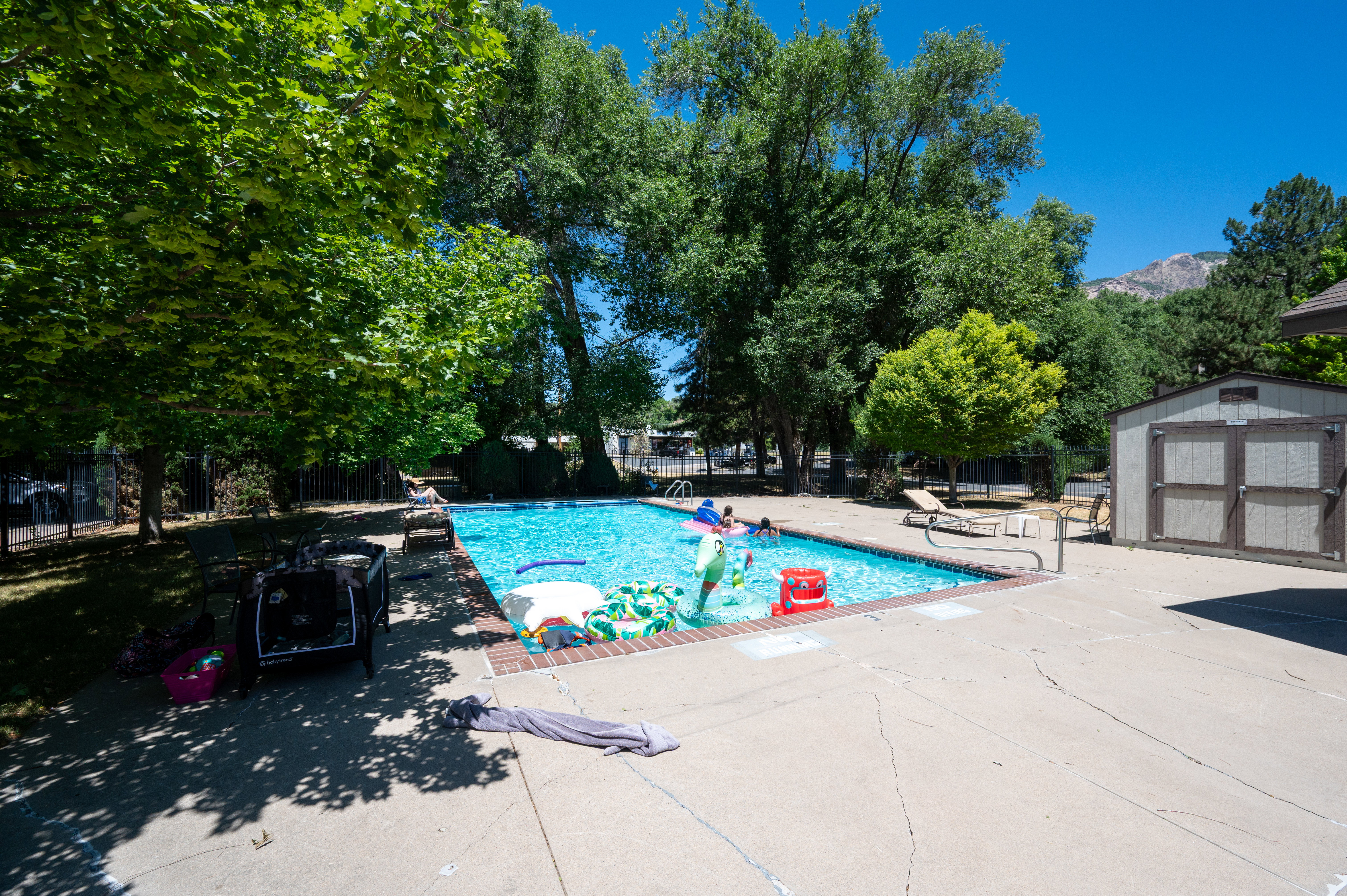 Rectangular in-ground swimming pool with brick coping and integrated handrail