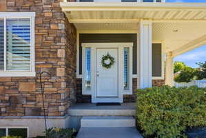Stone veneer exterior featuring a covered porch entry