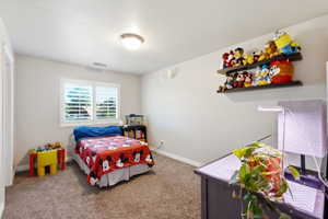 Bedroom featuring neutral wall paint and carpeted flooring
