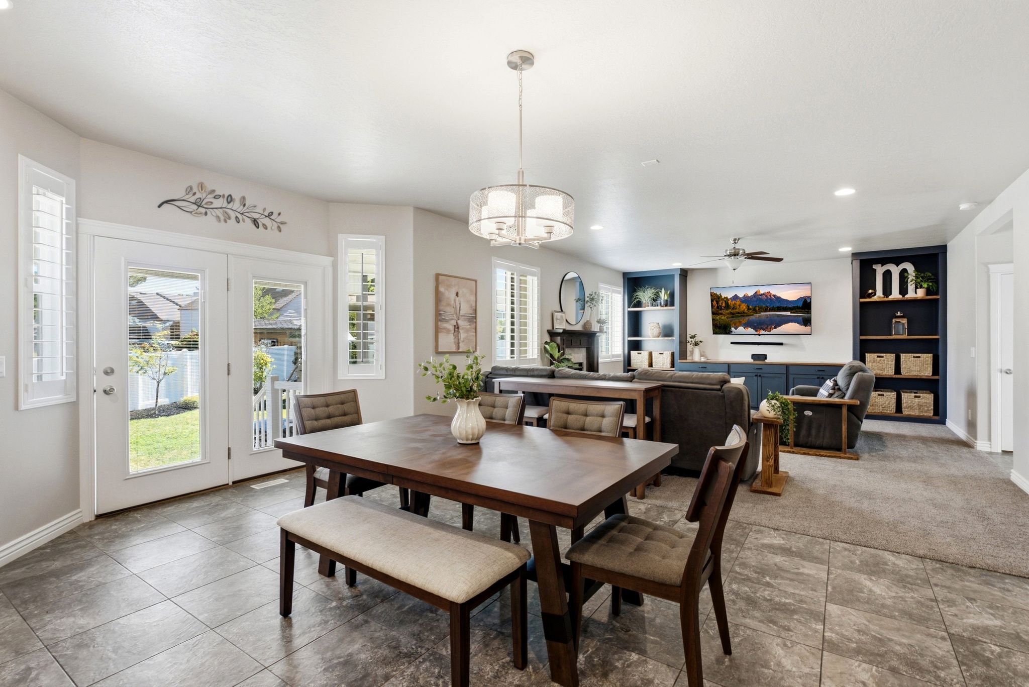 Dining area featuring tile flooring, a contemporary chandelier, and French doors leading to the exterior