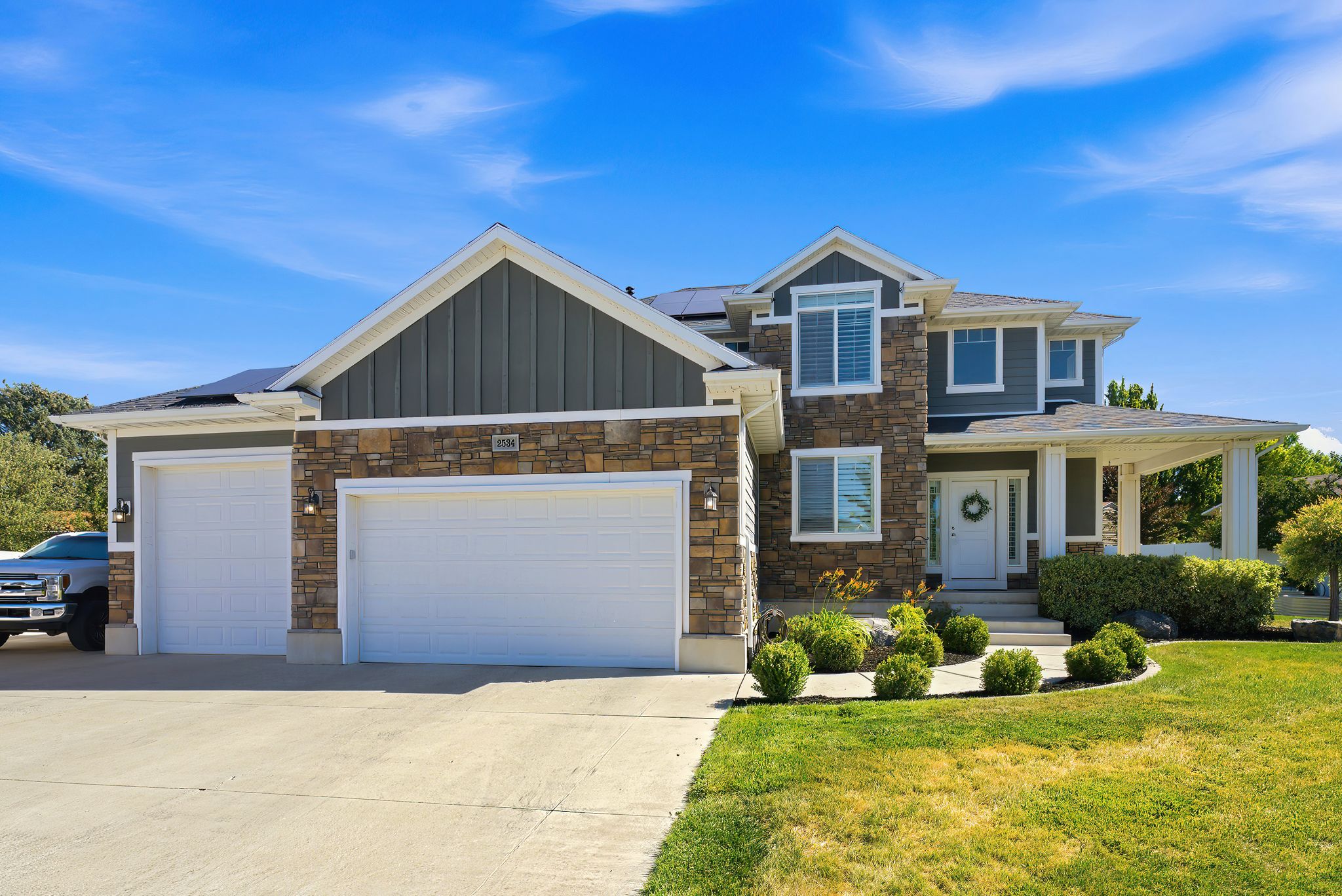 Contemporary two-story residence with a stone and siding exterior