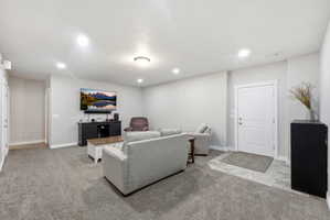 Spacious room with light gray walls and recessed lighting