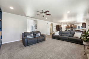Spacious living area with recessed lighting, ceiling fan, and carpet flooring