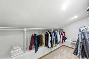 Custom closet system featuring white shelving and hanging rods
