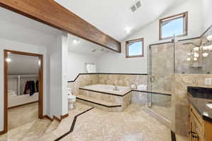Vaulted ceiling bathroom featuring a glass-enclosed shower, built-in soaking tub, tile flooring, and wood-beam accents