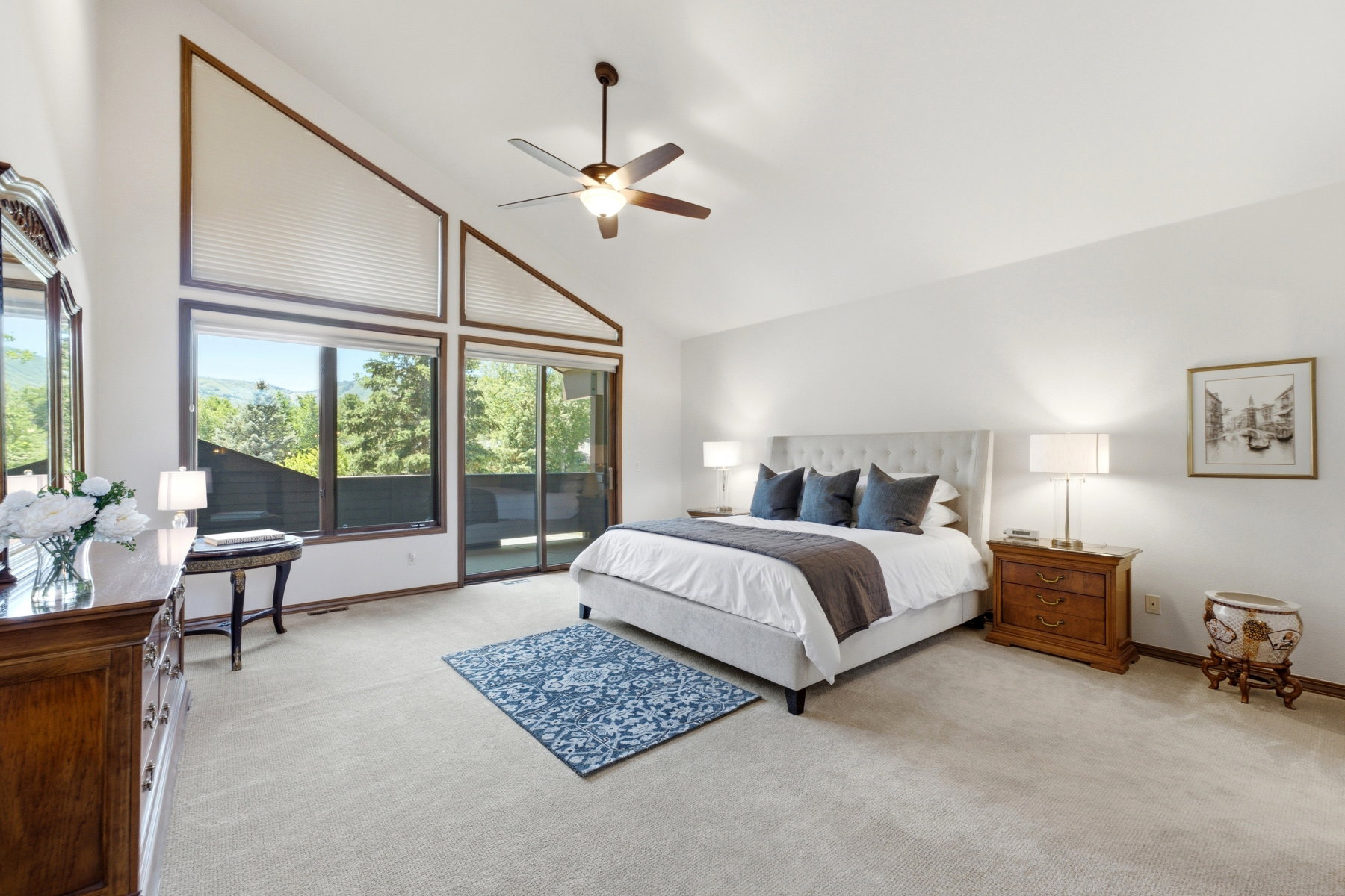 Soaring vaulted ceilings with expansive windows and a sliding glass door