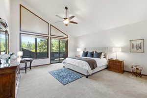 Soaring vaulted ceilings with expansive windows and a sliding glass door