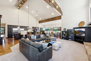 Great room featuring vaulted ceilings, exposed wood beams, and recessed lighting