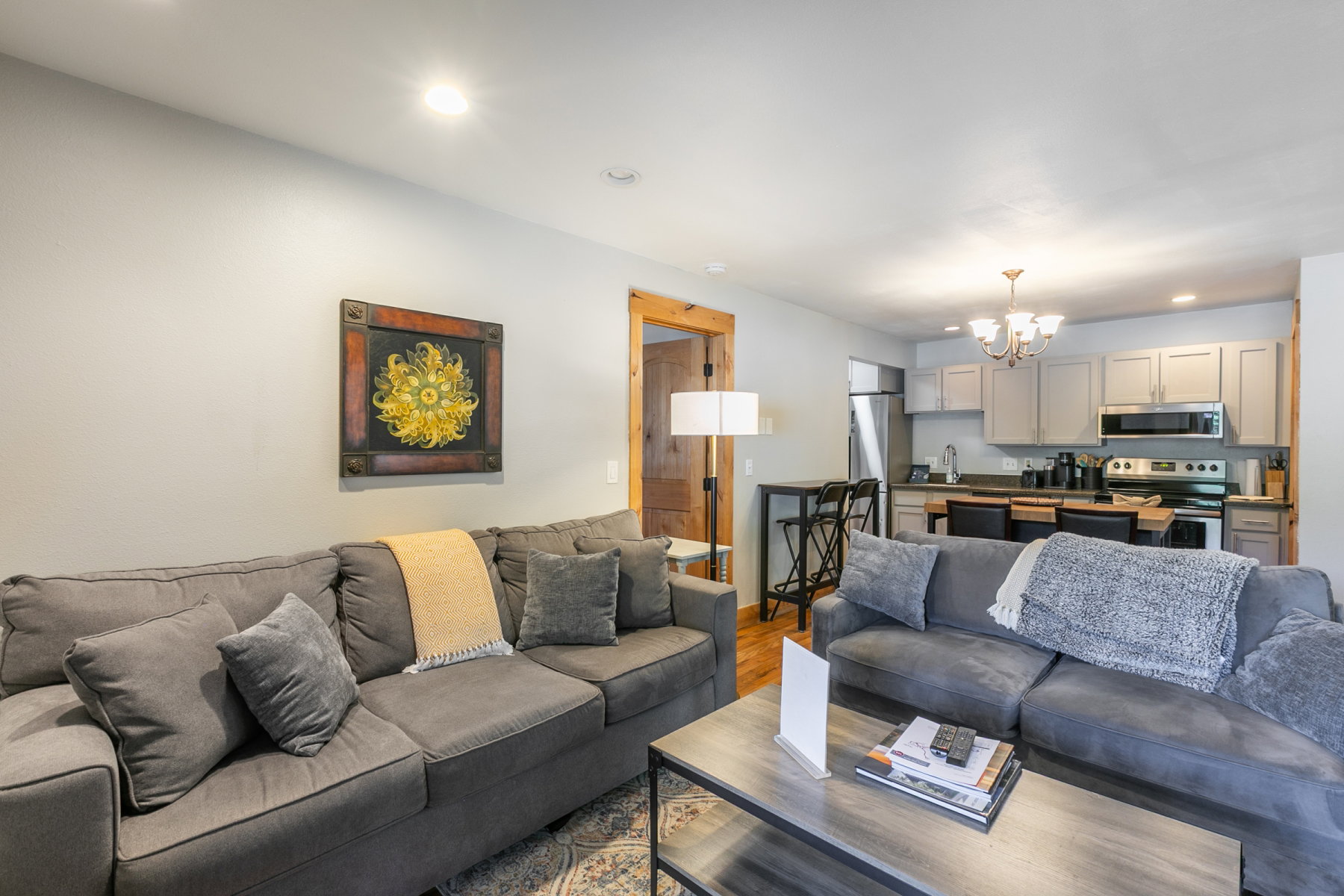 Open-concept living area featuring recessed lighting and wood-finish flooring