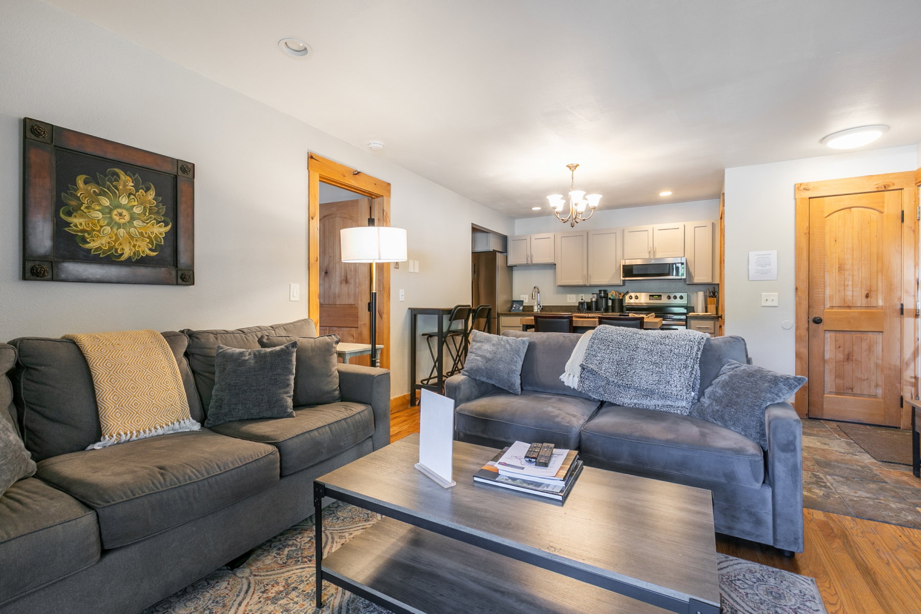 Open-concept living space featuring wood-finish flooring, light-toned walls, and a recessed ceiling light