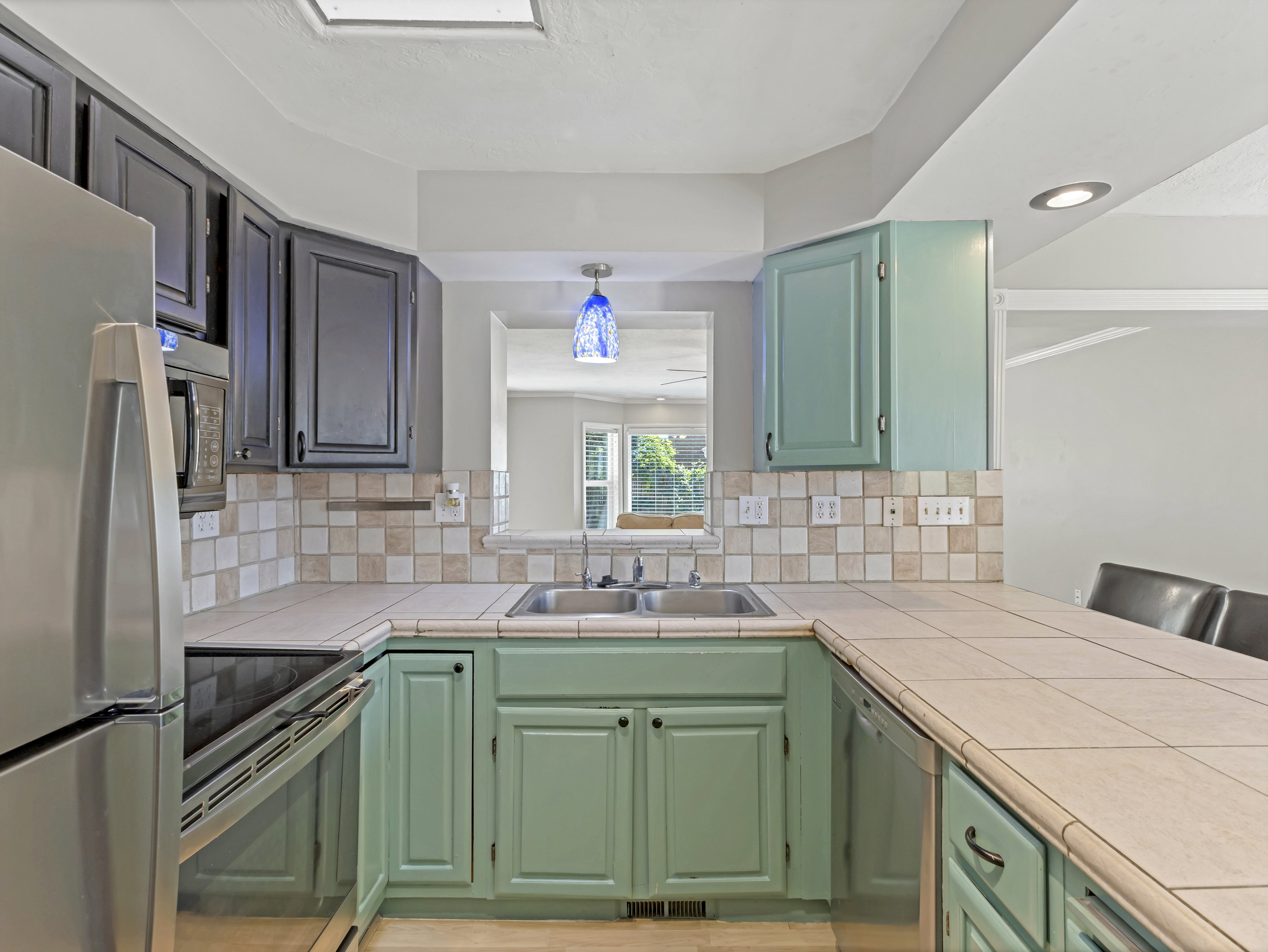 Kitchen featuring a double basin stainless steel sink and a tile backsplash
