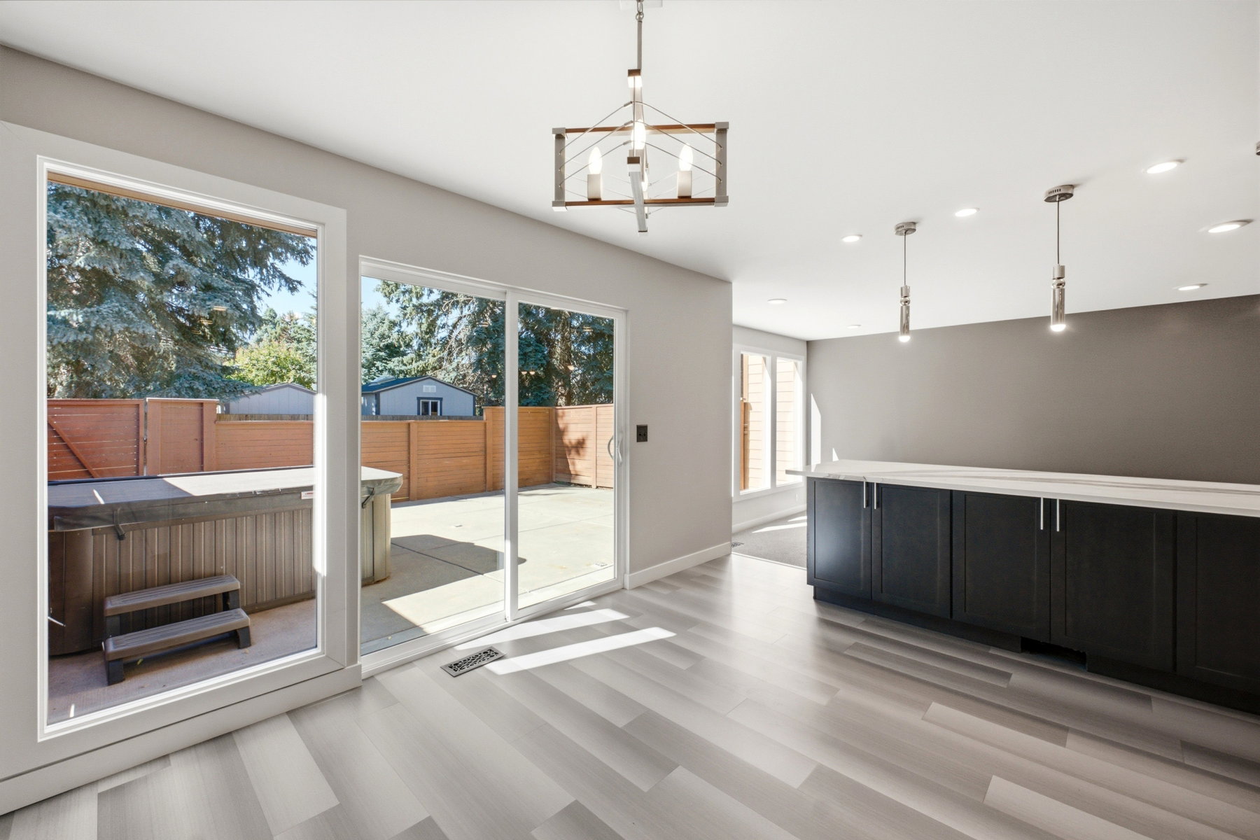 Backyard patio with hot tub and privacy fencing