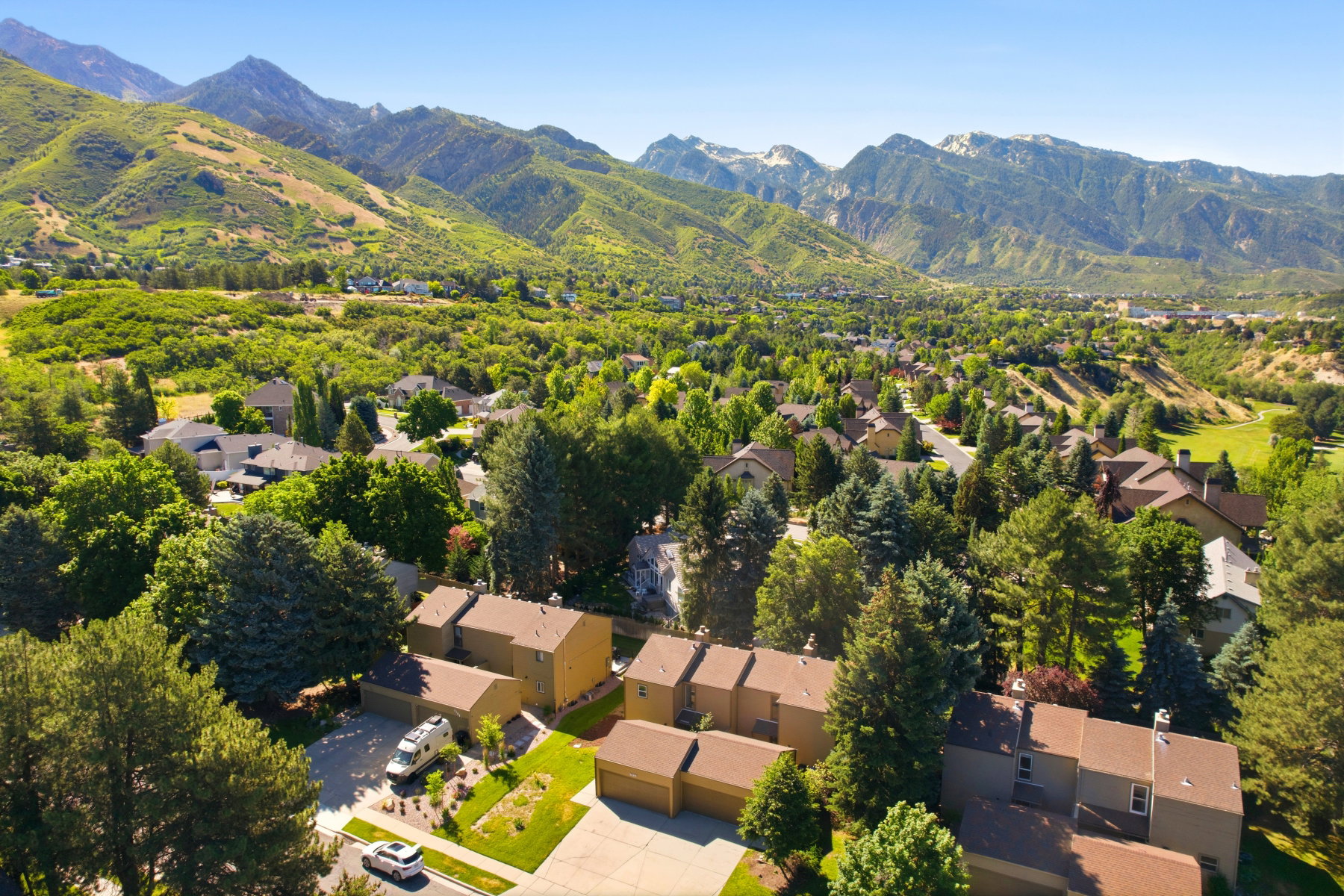 Mountainous terrain surrounding a residential area with dense tree coverage