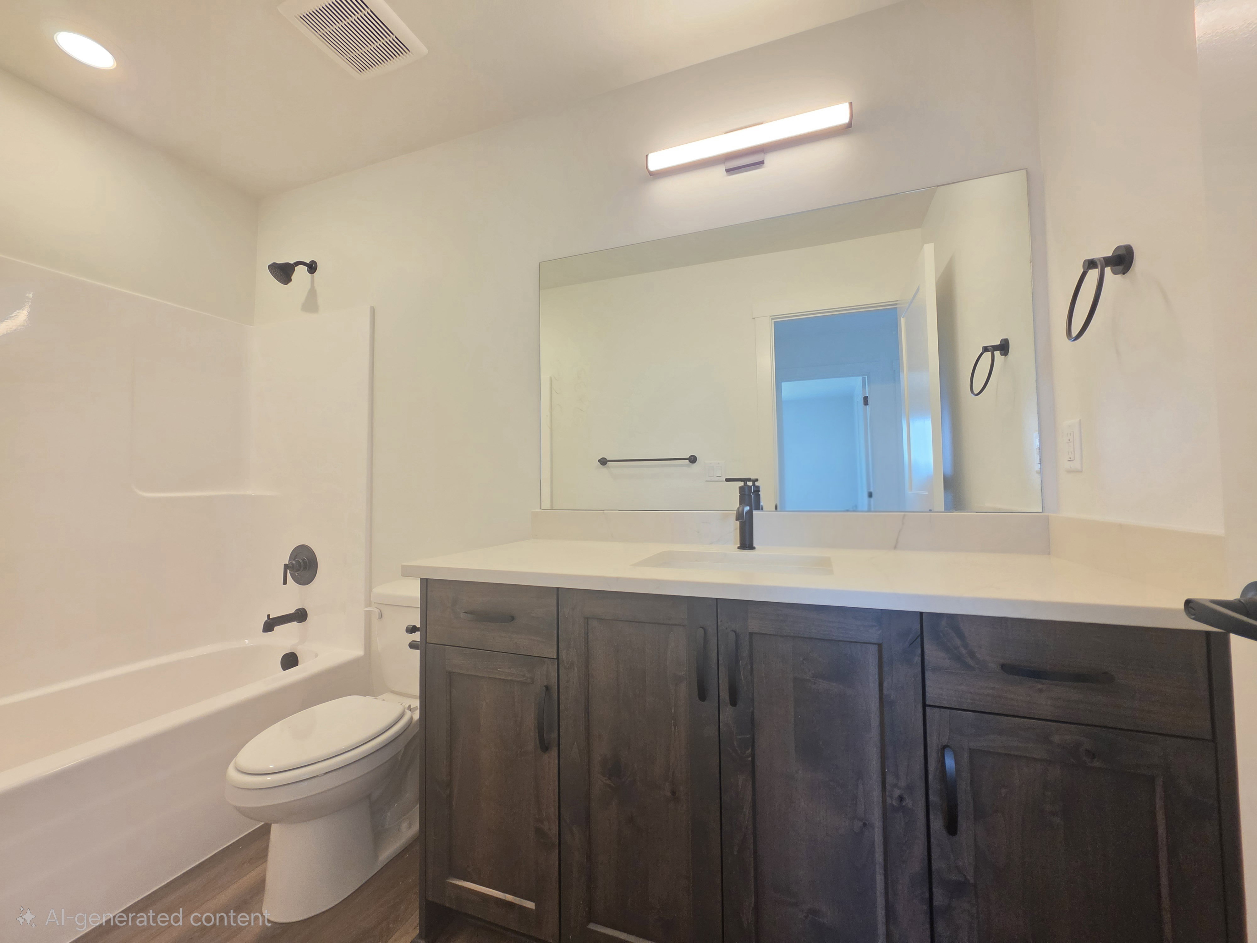 Bathroom vanity with a light-toned countertop and an integrated sink