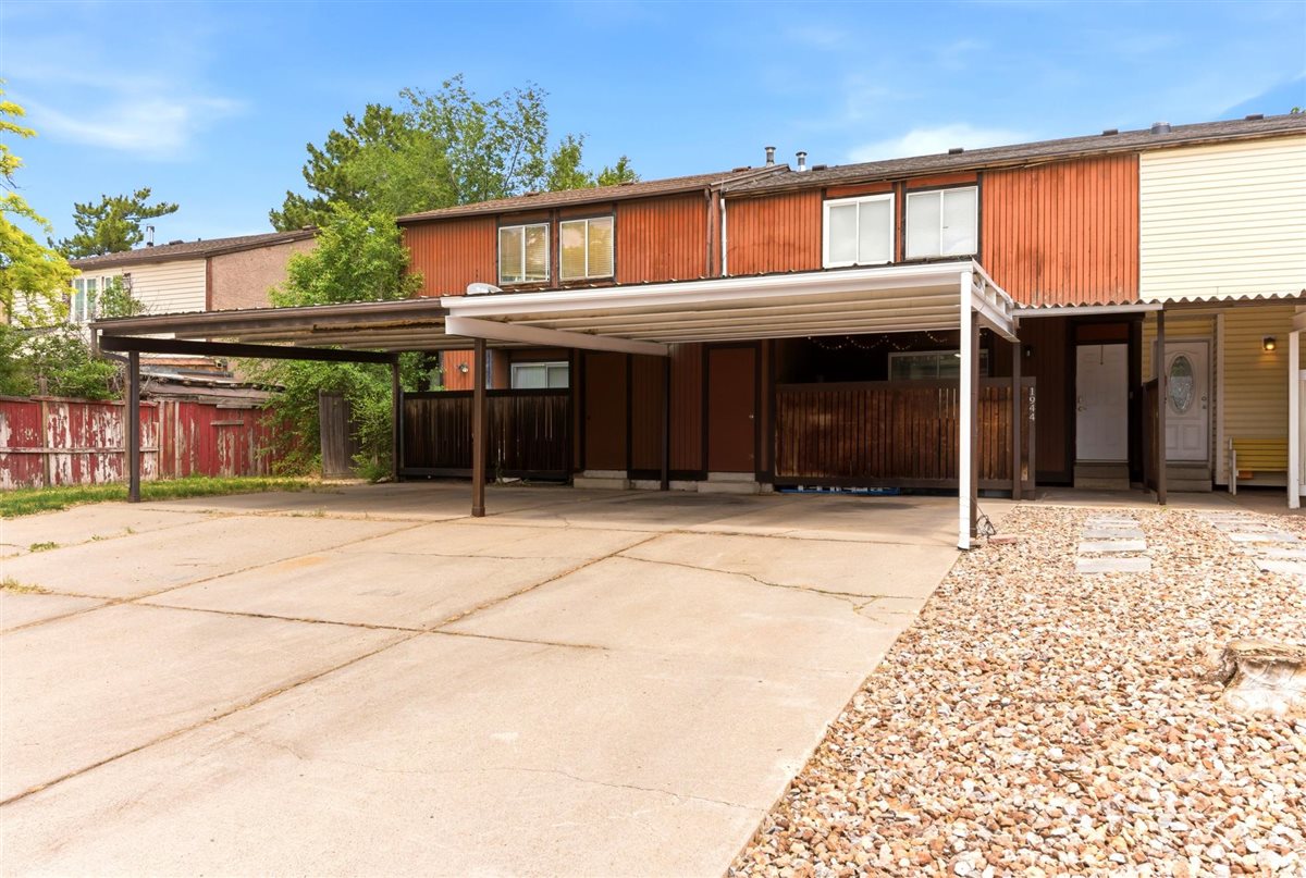 Concrete driveway with two attached carports providing covered parking