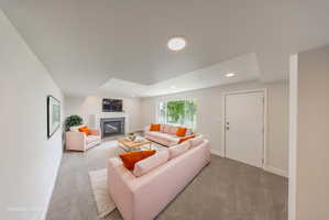Spacious living area featuring a central fireplace with an integrated television niche