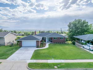 Classic brick rambler with a dark shingle roof and an attached two-car garage