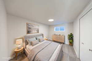 Bedroom featuring light gray walls, gray carpeting, a single window, and a white interior door