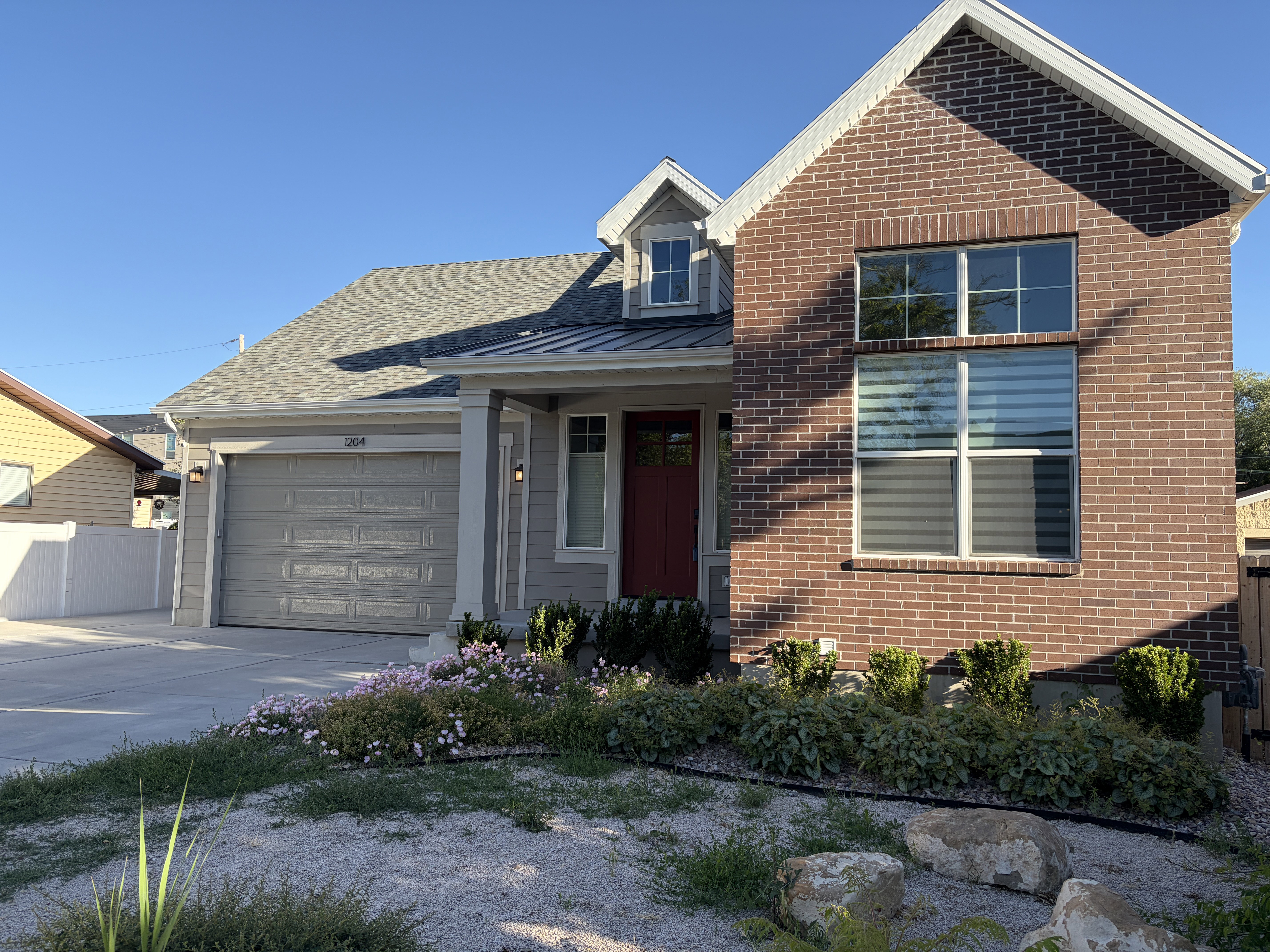 Modern facade featuring brick accents and light grey siding
